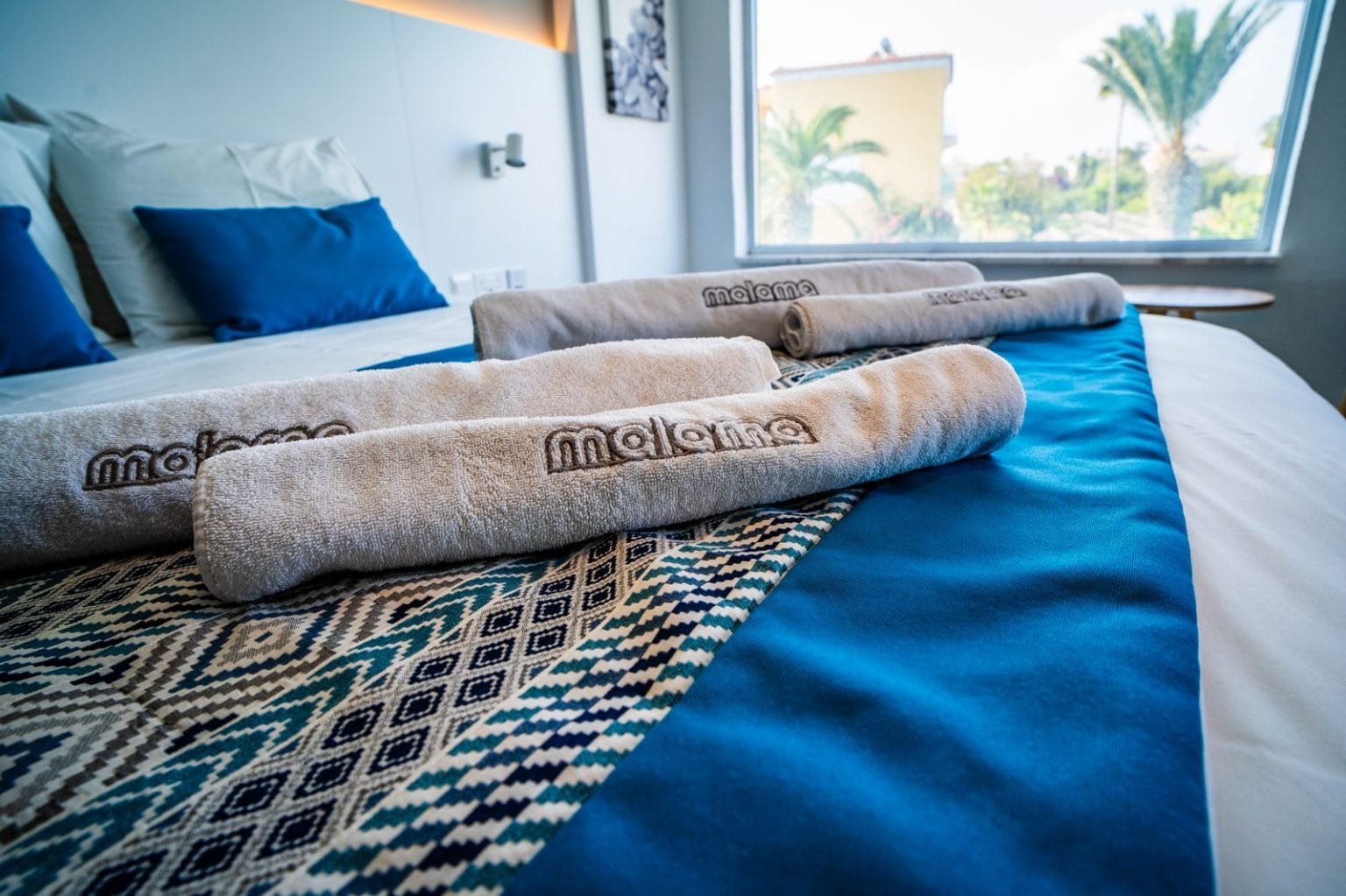 Made bed with towels in the Deluxe Sea View Suite, Malama Beach Holiday Village