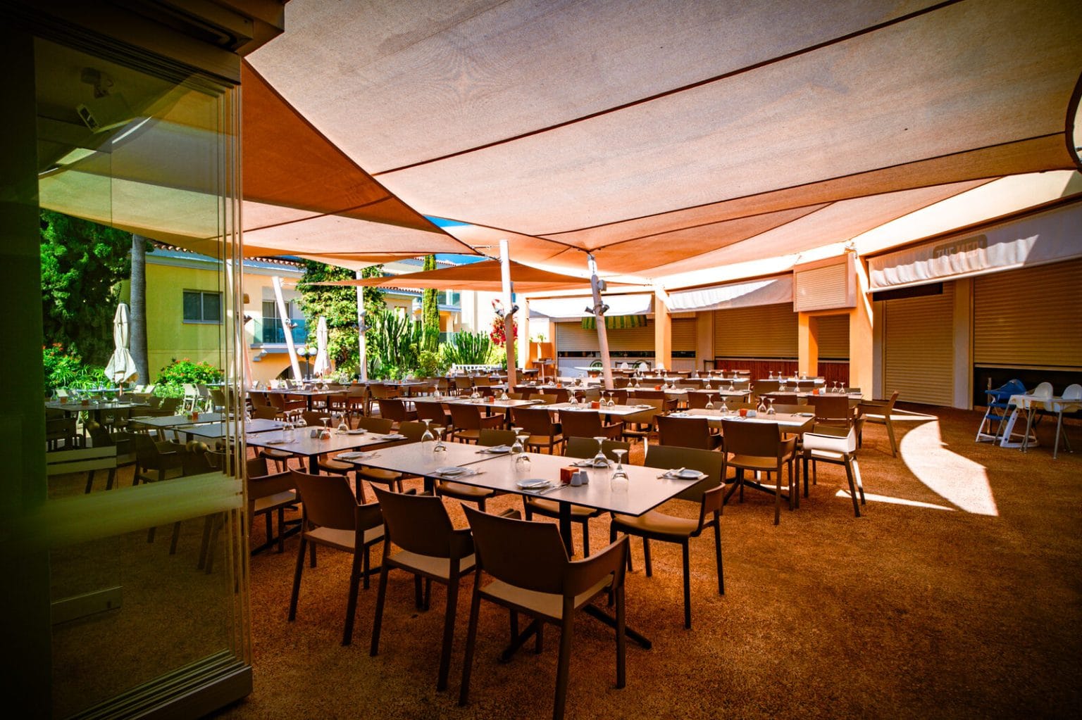 Set tables on the La Piazza terrace at Malama Beach Holiday Village, Protaras