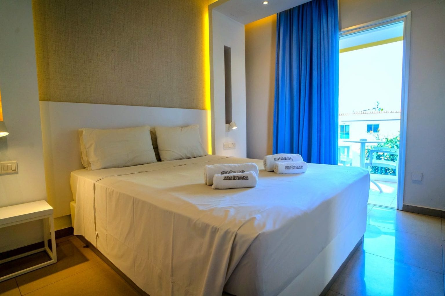 One-Bedroom Suite bedroom with balcony doors at Malama Beach Holiday Village