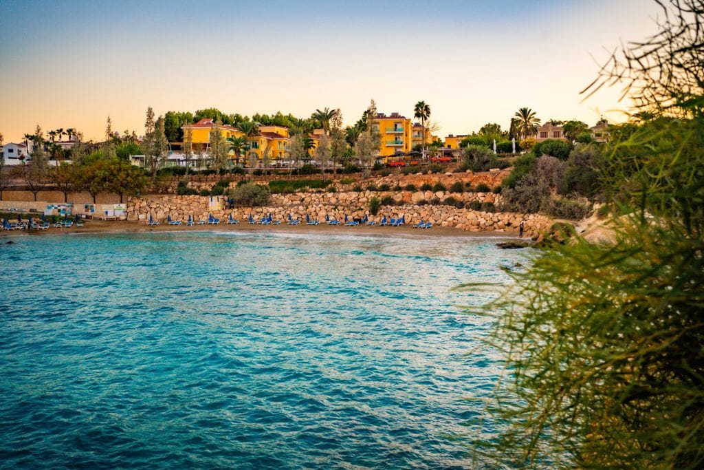 The resort's own sheltered cove and sandy beach with sun loungers at Malama Beach, Protaras.