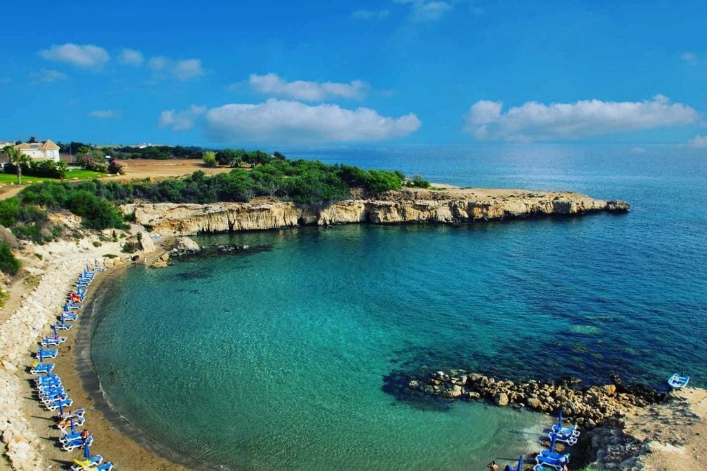 Aerial view of the sheltered sandy cove and turquoise water at Malama Beach, Protaras