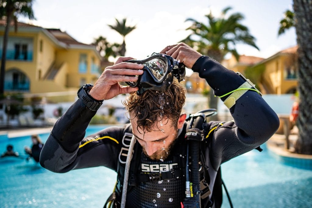 Diver fitting his mask before a dive at Malama Beach Holiday Village, Protaras