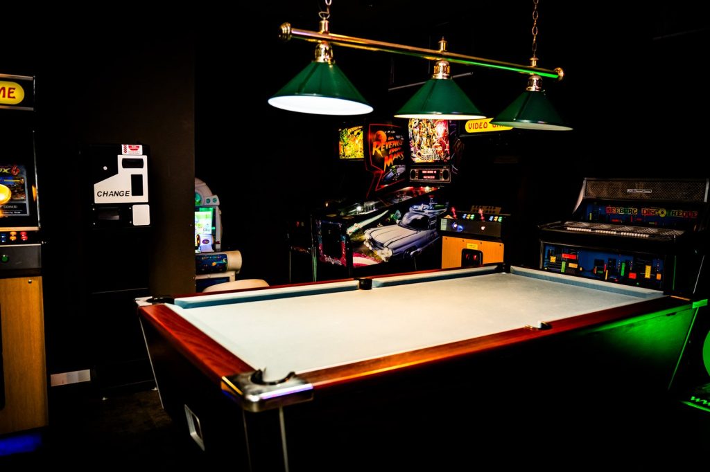Games room with a pool table and arcade machines at Malama Beach Holiday Village, Protaras