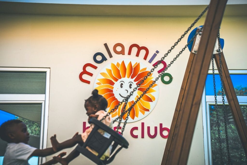 Children playing on the swings at the Malamino Kids' Club, Malama Beach Holiday Village, Protaras